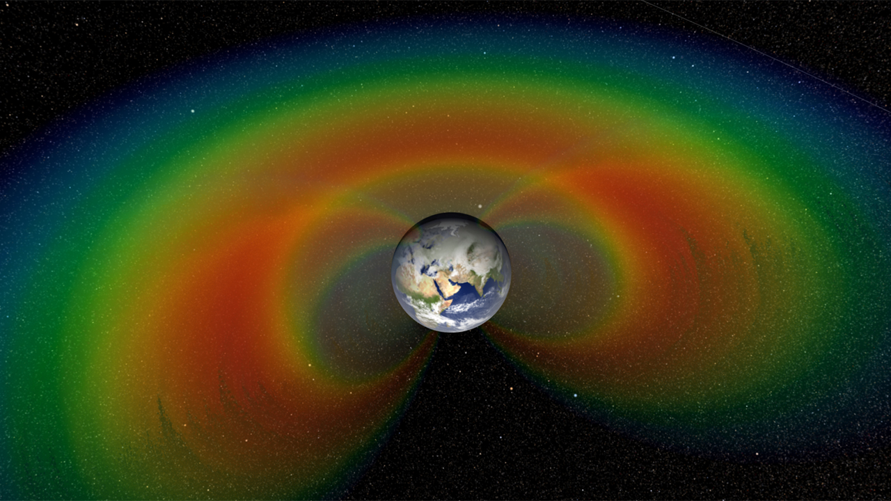 An artist's depiction with cutaway section of the two giant donuts of radiation, called the Van Allen Belts, that surround Earth.